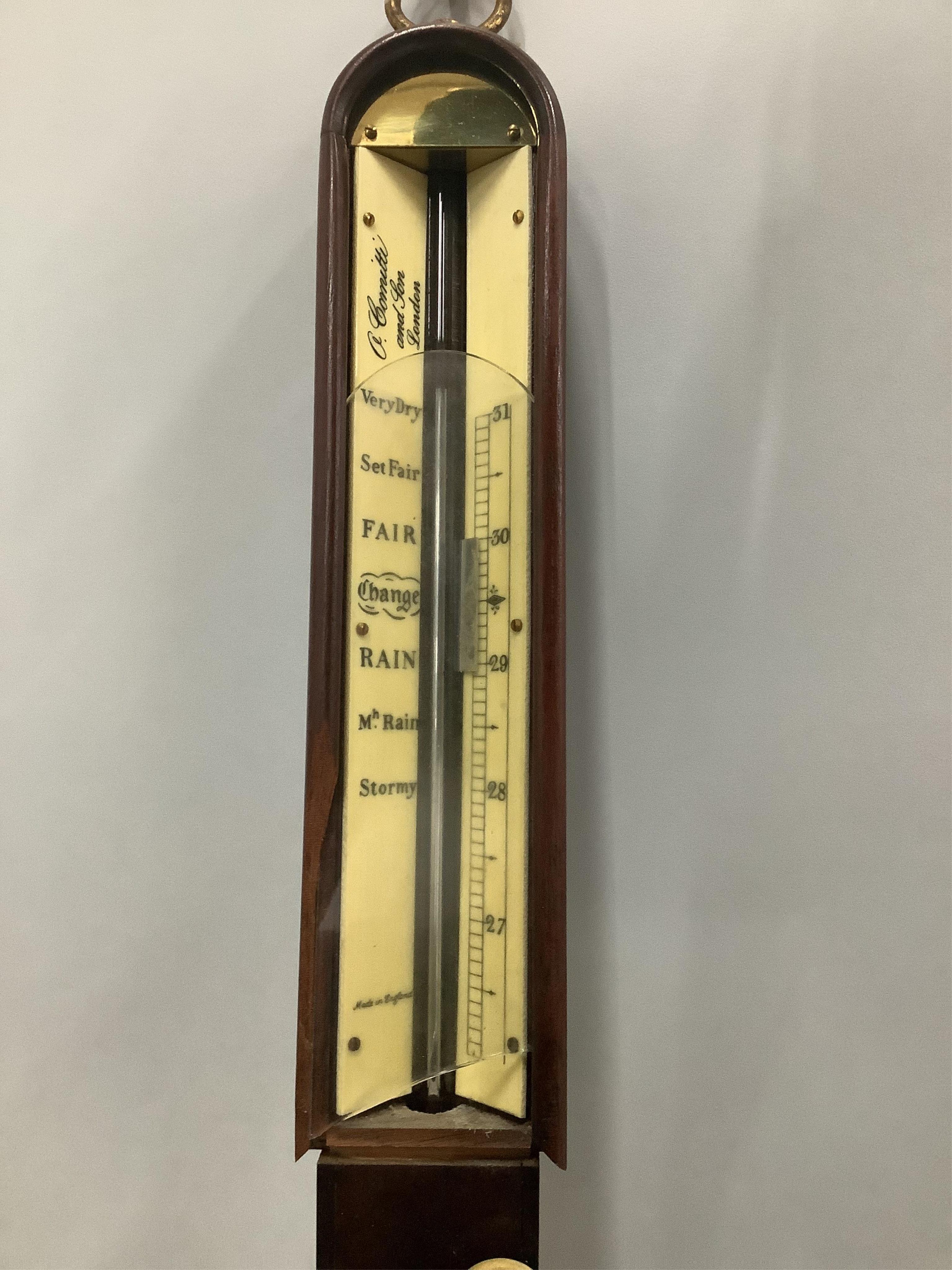 A reproduction mahogany ship's barometer, by A. Comitti & Son, London, on brass gimbal, height 93cm. Condition - fair